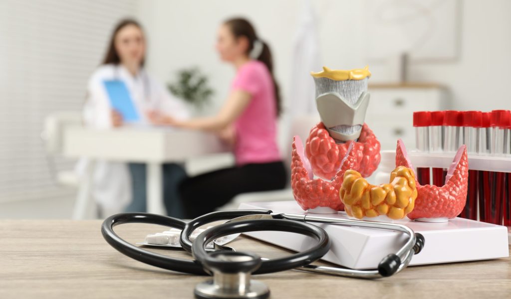 endocrinologist-examining-patient-at-clinic-focus