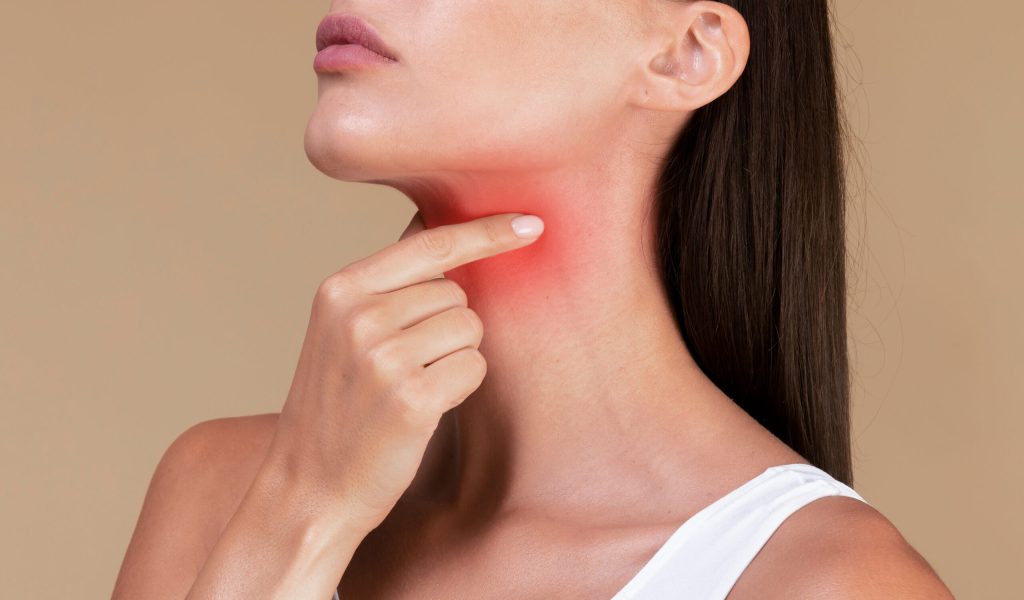 Healthcare concept. Closeup of unrecognizable sick lady suffering from sore throat, touching neck with hand, inflamed red zone, banner, cropped